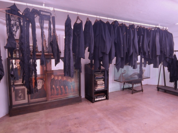 His new all black collection hangs in the showroom awaiting the next sample to arrive